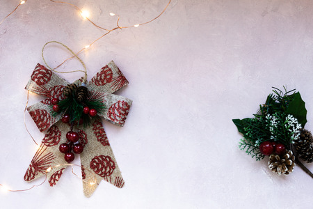 Christmas tree branch and decorations on light pink textured background. Christmas, new year, winter concept. Flat lay, top view, copy spaceの写真素材