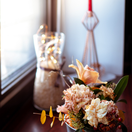 Bouquet of different flowers on the window sill, selected focus, blurred backgroundの写真素材