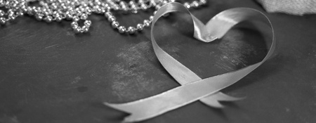 Black and white - red tape with gold beads on old dark background. Heart shape, banner, valentine's day conceptの写真素材