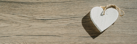 White heart on wooden background, simple composition, Valentines day concept, banner