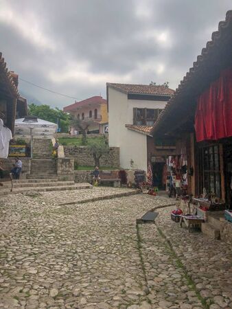 Kruje, Albania - June 2018: Traditional Ottoman market in Kruja, birth town of National Hero Skanderbeg. Flea market in Albania. Antique items and wool craft souvenirs for sale.のeditorial素材