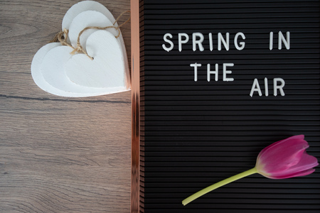 Spring is in the air text on dark and white background, inscription, copy spaceの写真素材