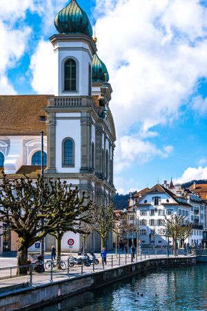 LUCERNE, SWITZERLAND - March, 2017: cityscape view of Chapel bridge and historic city center of Lucerne with famous lake Lucerne (Vierwaldstattersee) with beautiful reflections of houses in the waterのeditorial素材