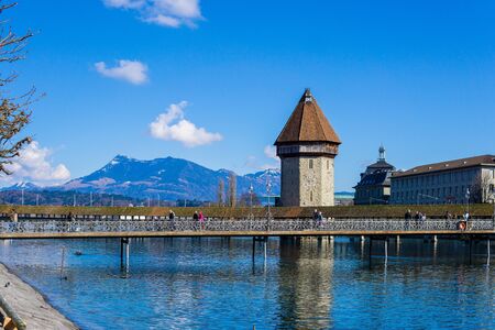 LUCERNE, SWITZERLAND - March, 2017: cityscape view of Chapel bridge and historic city center of Lucerne with famous lake Lucerne (Vierwaldstattersee) with beautiful reflections of houses in the waterのeditorial素材
