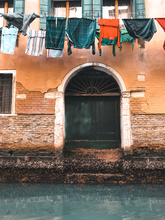 Wood door and window. On redbrick wall, building facade in Venice, exterior designの写真素材