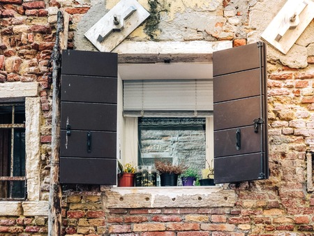 Wood door and window. On redbrick wall, building facade in Venice, exterior designの写真素材