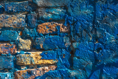 Close up of bright blue painted stucco and brick wall on Burano Island near Venice, Italy. Background texture.の写真素材