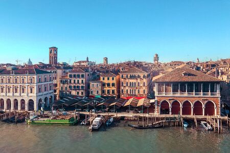 Venice, Italy - Mart 2019: Aerial view of Rialto Market with gondola passing from Grand Canalのeditorial素材
