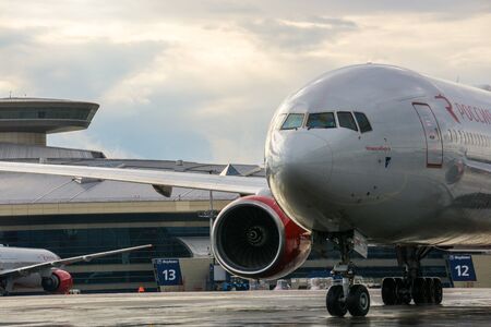 Moscow, Russia, July 2017 - Vnukovo International Airport. White passenger plane takes off from the airport runway. Airplane front view.のeditorial素材