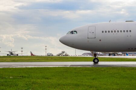 Moscow, Russia, July 2017 - Vnukovo International Airport. White passenger plane takes off from the airport runway. Airplane front view.のeditorial素材