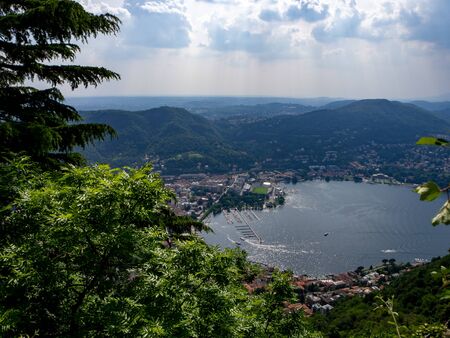 View above big beautiful lake, Como lake, Italy. Summer cloudy view. With stony shore