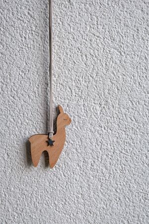 Wooden Llama, as a symbol of new trend, on white background, verticalの写真素材