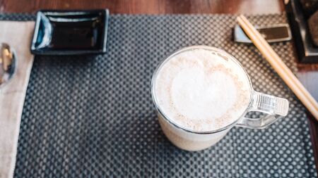 Coffee cup with latte art on cafe wood table banner panorama backgroundの写真素材