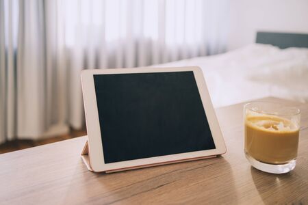 Digital tablet touch pad computer on the able, work from home, coffee, phone, room