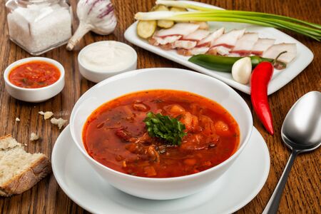Ukrainian national red borsch in a plate with herbs and spicesの写真素材