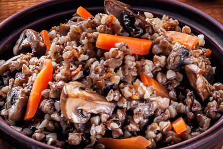 buckwheat porridge with fried mushrooms and carrots closeupの写真素材