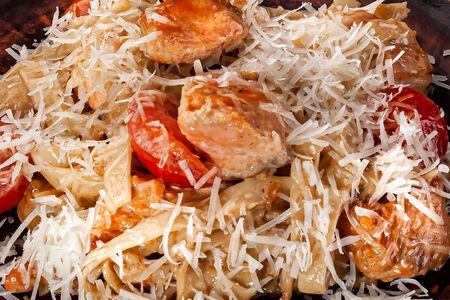pasta with salmon, cheese and tomatoes closeup food backgroundの写真素材