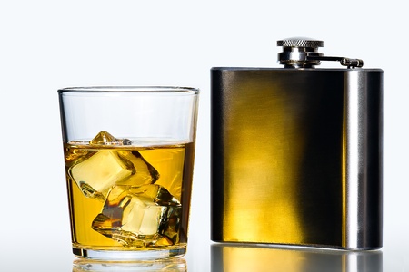 glass of whisky on the rocks  and stainless flask on white backgroundの写真素材
