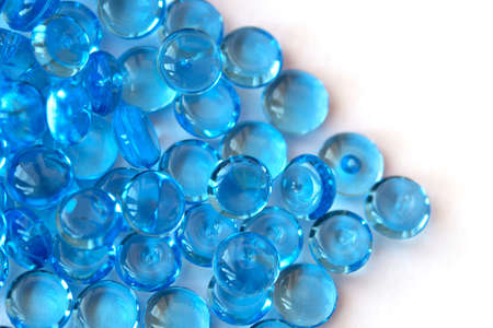 Transparent blue glass marble beads isolated on white background. Acrylic ice stones for decoration....
