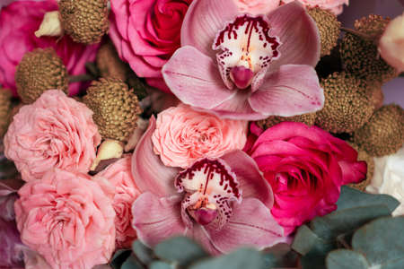 Bright pink flowers bouquet closeup. Roses and orchids wallpaper. Beautiful background for a Birthday, International Female Day, or Saint Valentine. The festive backdrop for a postcard designの写真素材