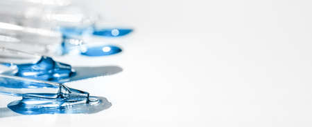 Pipettes with fluid hyaluronic acid on white background. Cosmetics and healthcare concept closeup....