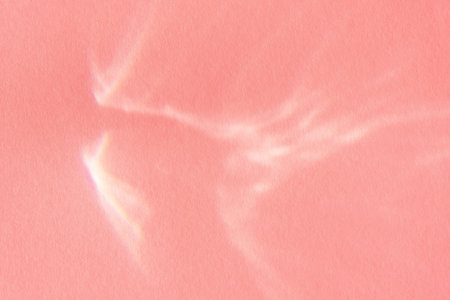 Beautiful lights and shadows of glass on pink background. Overlay mode. Caustic effect of light. Sun...