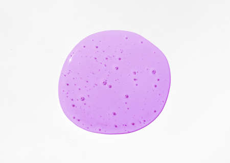 Violet cosmetics gel, serum or peeling drop on white background. Colorful slime with air bubbles in the sunlight. High contrast trendy photo. Health protection, skin care conceptの写真素材