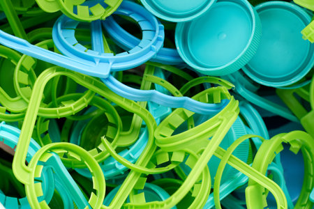 The concept of caring for the environment. Many different plastic bottle caps for recycling. Screw caps rings rubbish. Eco friendly theme - care about the Earth. Avoid pollutionの写真素材