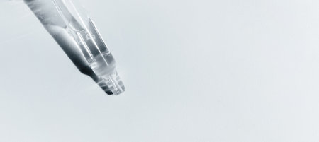 Face serum in transparent glass pipette. Natural oil, gel, cleaner. Cosmetics and healthcare concept...