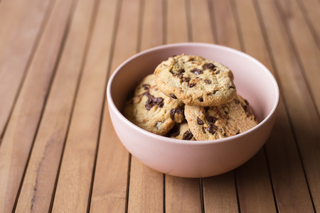 Pink Bowl of cookies on a table woodenの写真素材