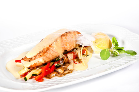 Baked sea bass fillet with vegetables, lemon and basil