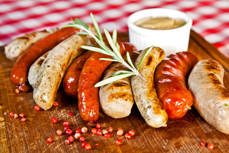 Grilled assorted sausages with spices and rosemaryの写真素材