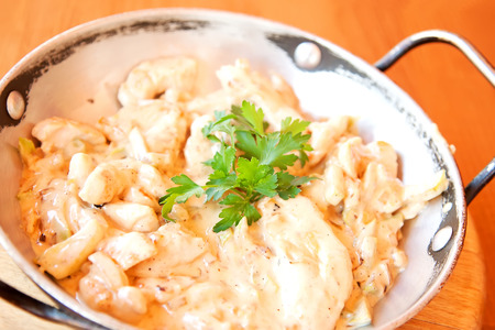 Chicken stew with sour cream sauce, vegetables and parsley twigの写真素材