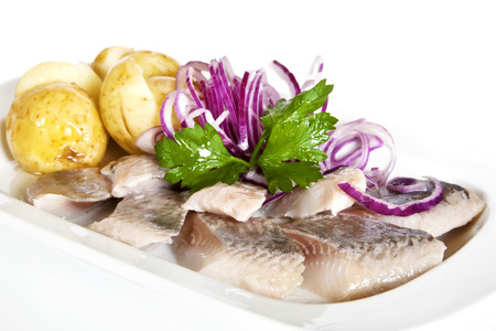 New potatoes, pickled herring, red onion and parsley twigの写真素材