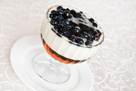 Bilberry and sour cream jelly with berriesの写真素材