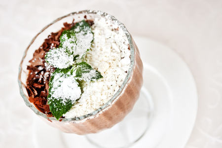 Tiramisu with grated chocolate and mint twigの写真素材