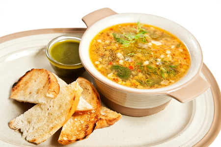 Vegetable minestrone soup with toasted bread and pesto sauceの写真素材