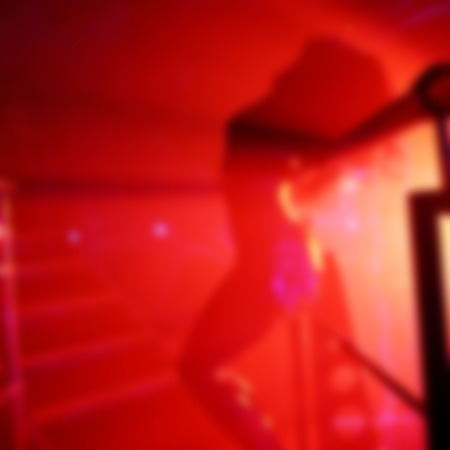 Abstract blurred image of dancing woman in night club as a background for your designの写真素材