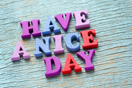 Have a nice day phrase made of wooden colorful letters on vintage backgroundの写真素材