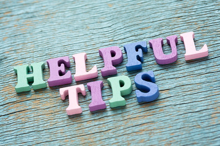 Helpful tips phrase made of wooden colorful letters on vintage backgroundの写真素材