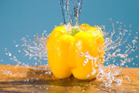 concept of fresh vegetable, splash and yellow bell pepperの写真素材