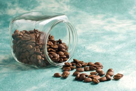 Coffee with beans in glass jar on special retro backgroundの写真素材