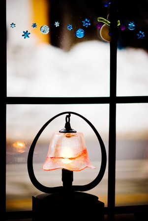 little light with glass lampshade decoration near the windowの写真素材