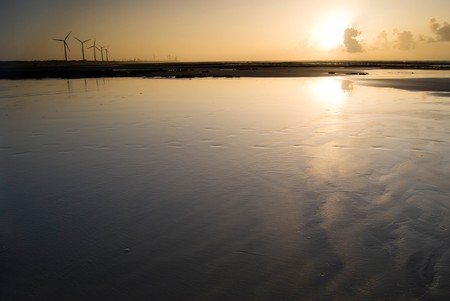 Sunset in the beach. Seashore with wind power  generator.の写真素材