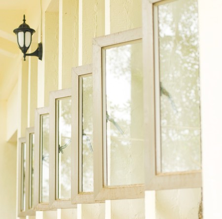 Row of opened windows in white building