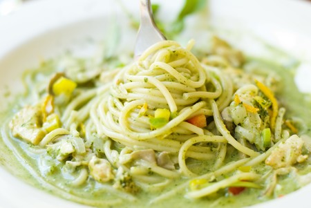 Stirring delicious noddles by fork. Lunch in white dishの写真素材