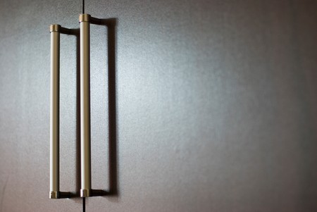 wardrobe with silver handles under soft lightの写真素材