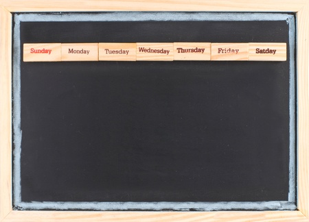 Monthly calendar with week words print on wood on blackboardの写真素材