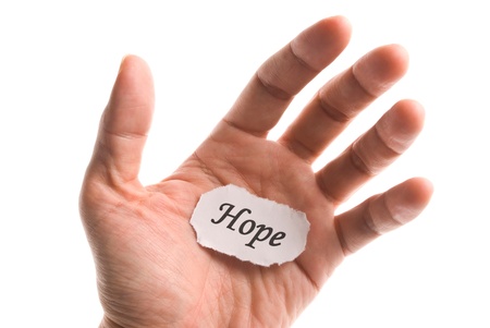 Hope word in hand, word on piece tear paperの写真素材