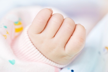 Lovely little clenched hand, infant hand. の写真素材